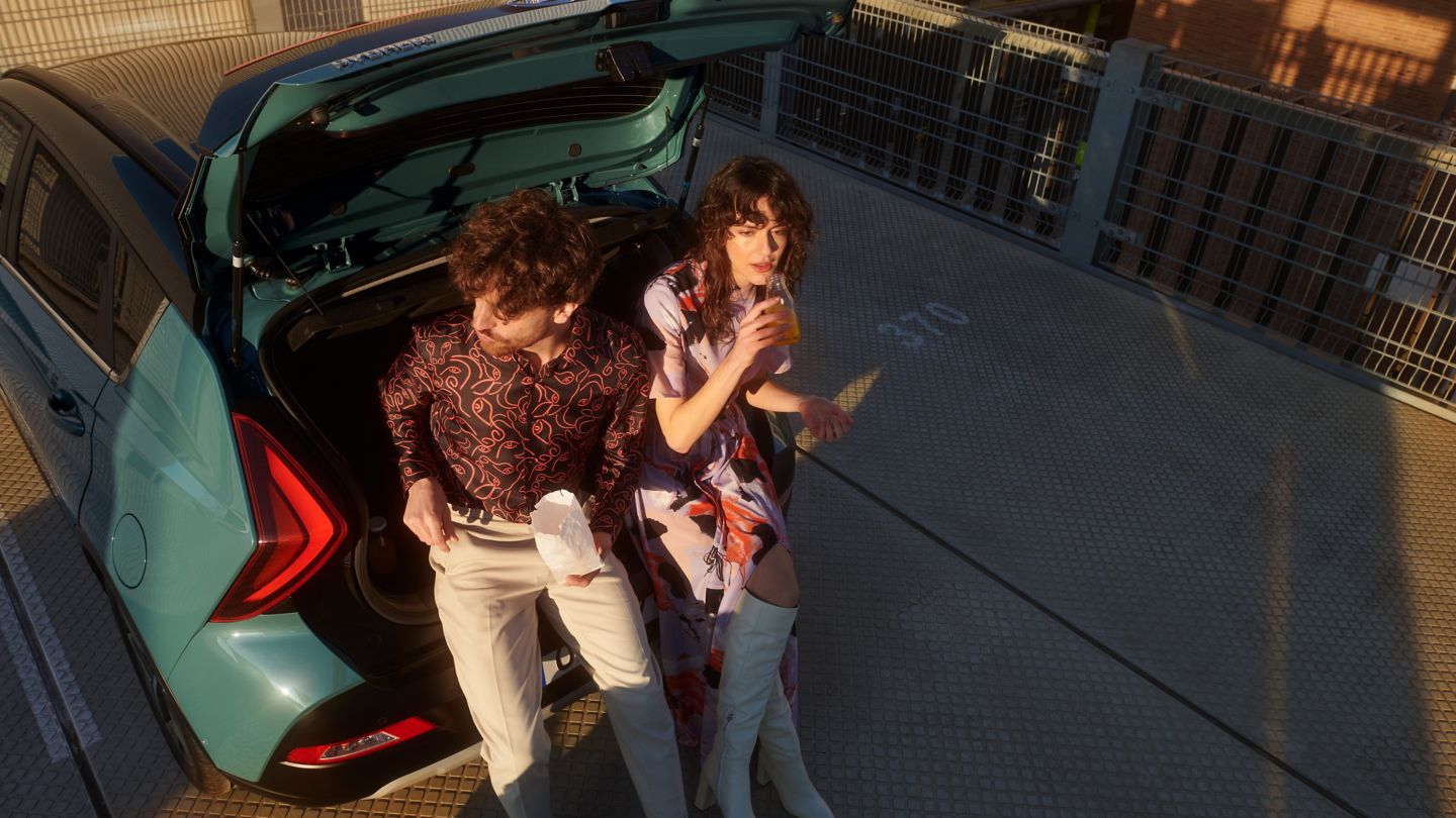 Couple sitting in the boot room of the all-new Hyundai BAYON compact crossover SUV.
